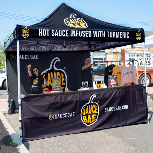 Picture of the Sauce Bae team in their Sauce Bae Branded tent